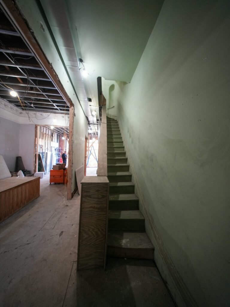 Interior of a Brooklyn brownstone in Park Slope showing an original staircase and woodwork
